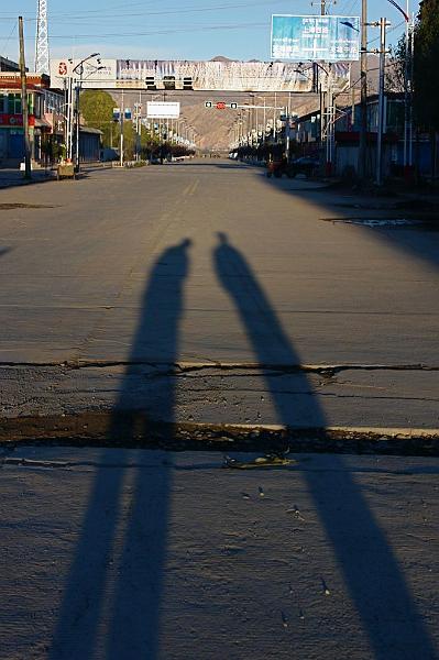 089 Stan & Sam cast long shadows on the street in Gyantse.jpg